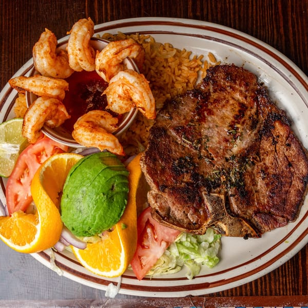 Happy Mexican's grilled steak and shrimp with rice, avocado, orange, tomato, and lime.