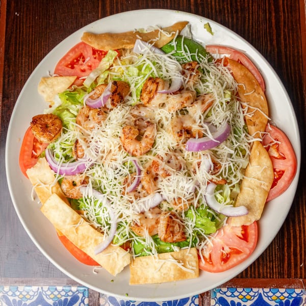 Happy Mexican's shrimp salad with lettuce, tomatoes, onions, cheese, and tortilla strips.